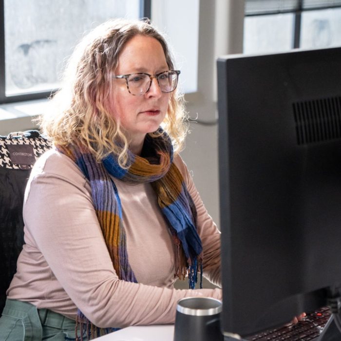 Washington business license specialist behind a computer